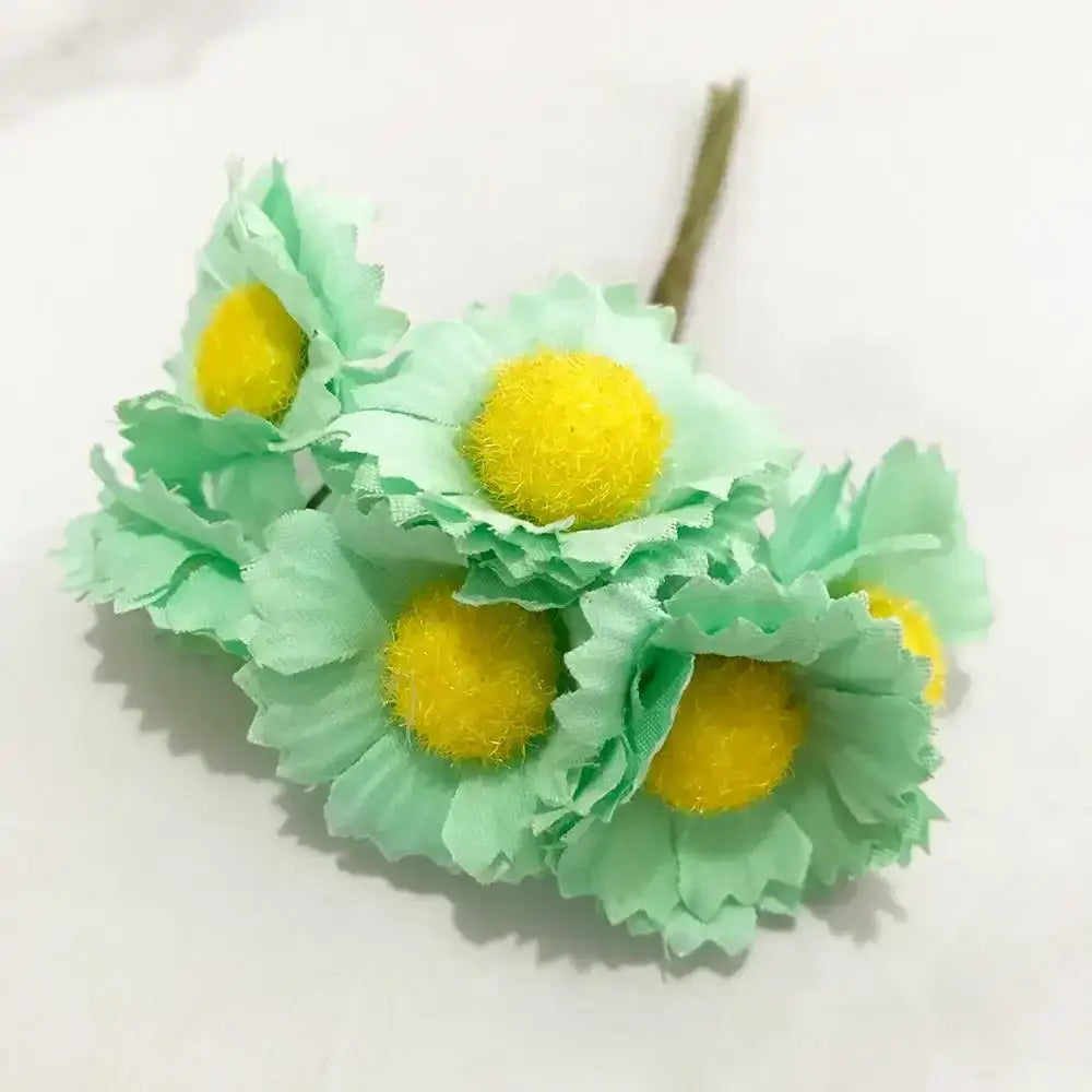 A stamen berries bundle of artificial mint green daisies with fluffy yellow centers for kitchen cake decor