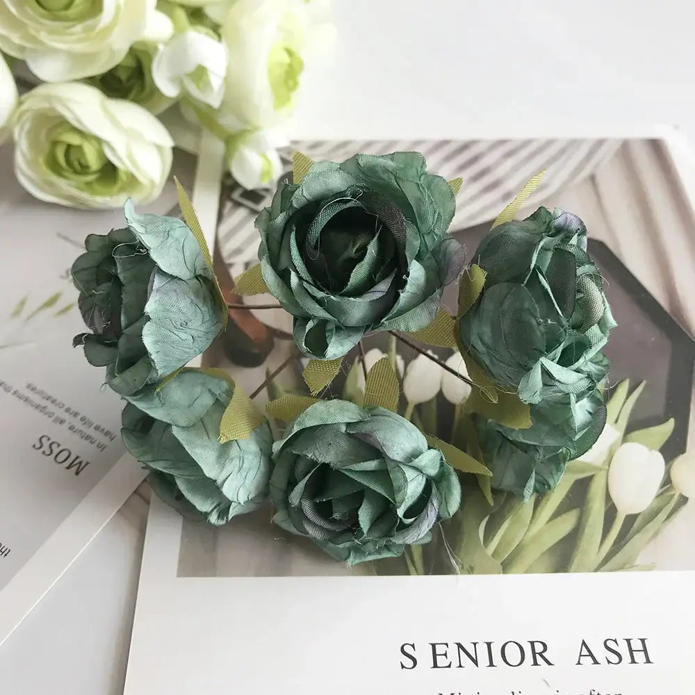A stamen berries bundle of artificial green fabric roses with subtle metallic sheen for kitchen cake decor featuring blue flower stamen