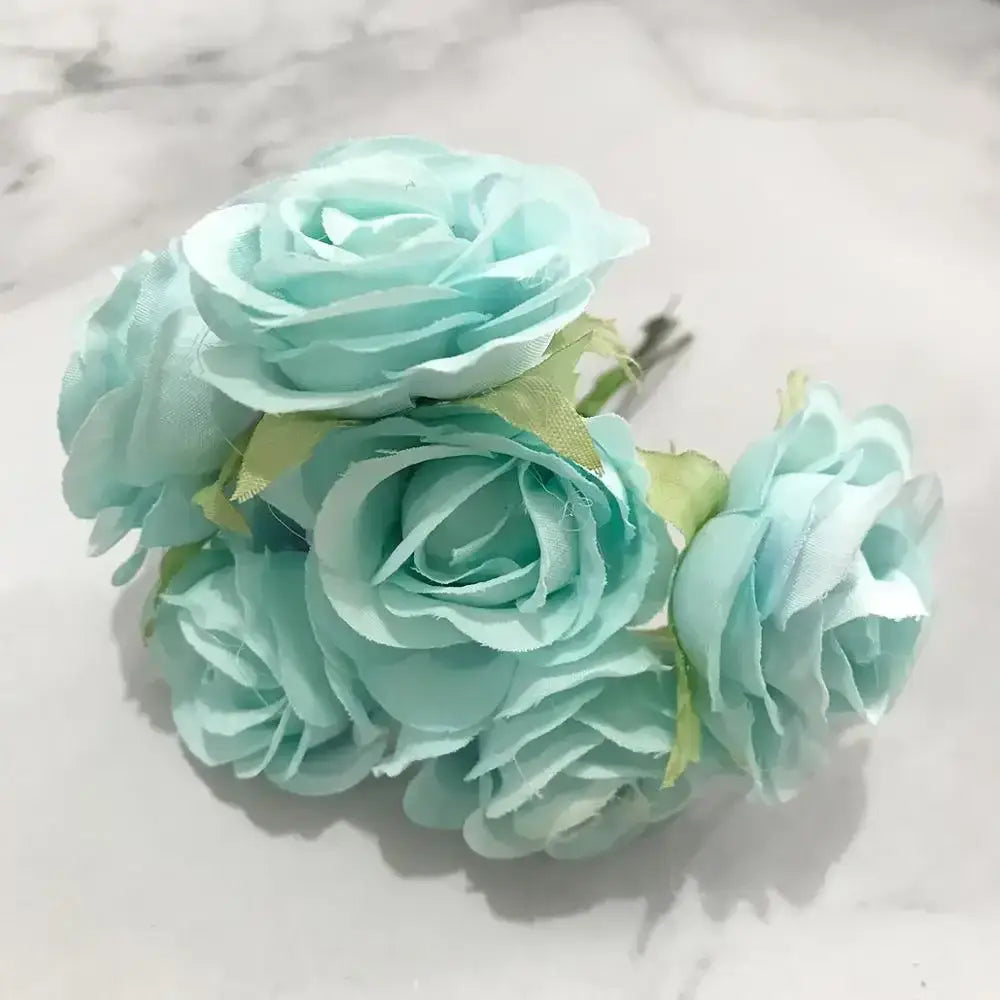 A cluster of delicate light blue fabric blue flower stamen with subtle green stems in a flower stamen berries bundle for decor