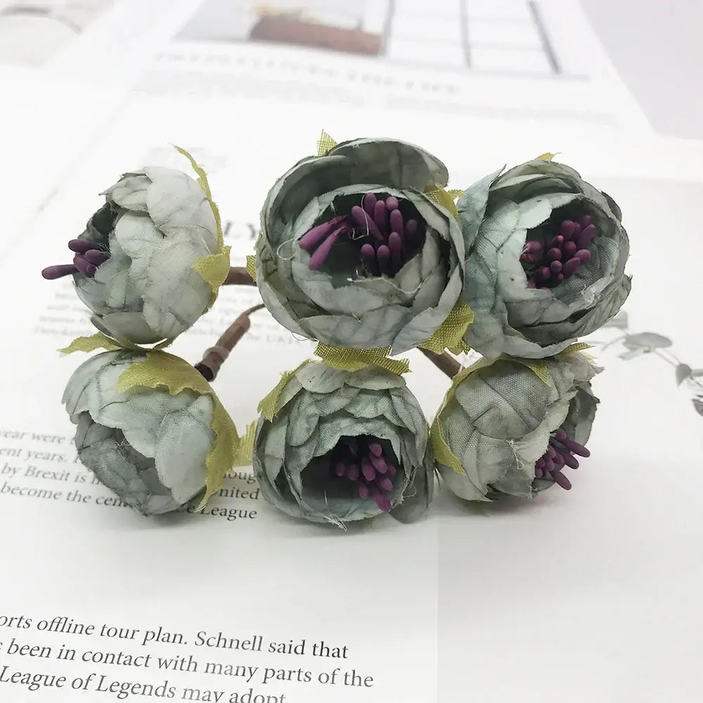 A stamen berries bundle of five artificial pale gray fabric peonies with deep purple blue flower stamen tied by yellow ribbon