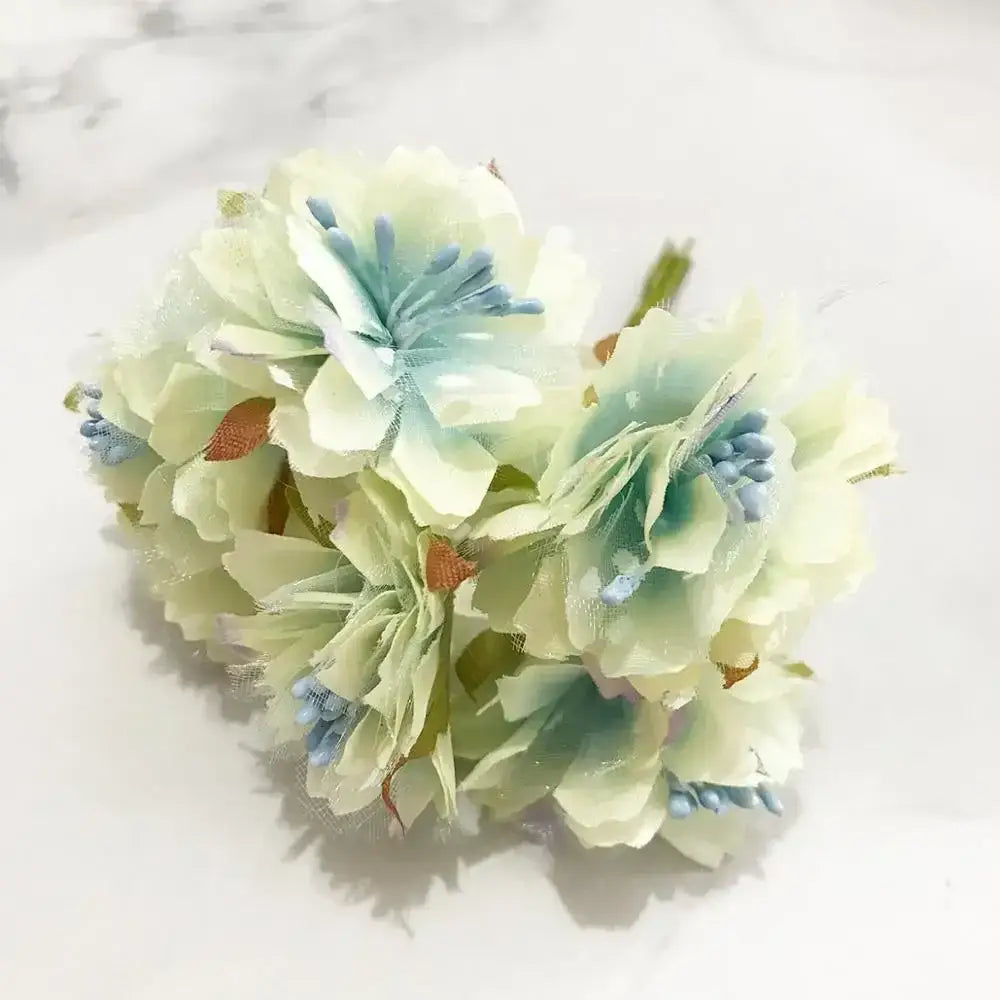 A delicate blue flower stamen berries bundle with pastel layered petals and orange buds for kitchen cake decor