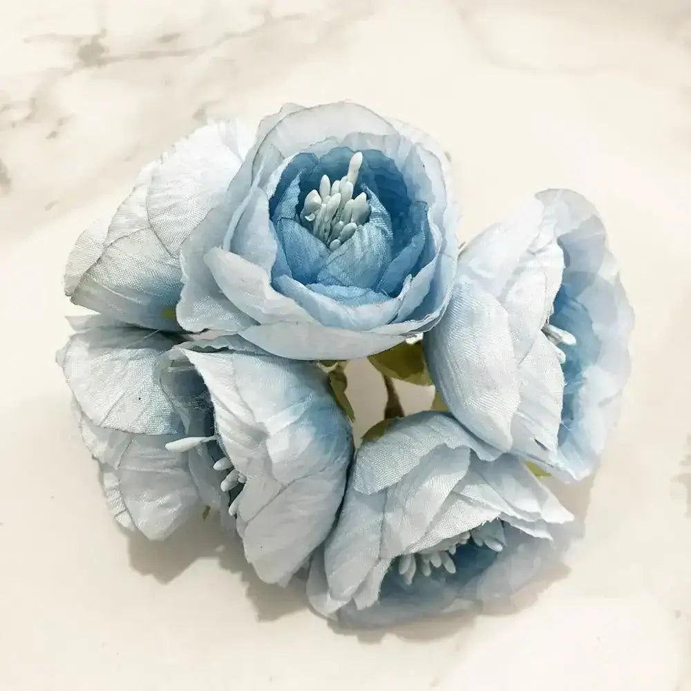 A delicate cluster of light blue fabric blue flower stamen berries with soft layered petals for kitchen cake decor