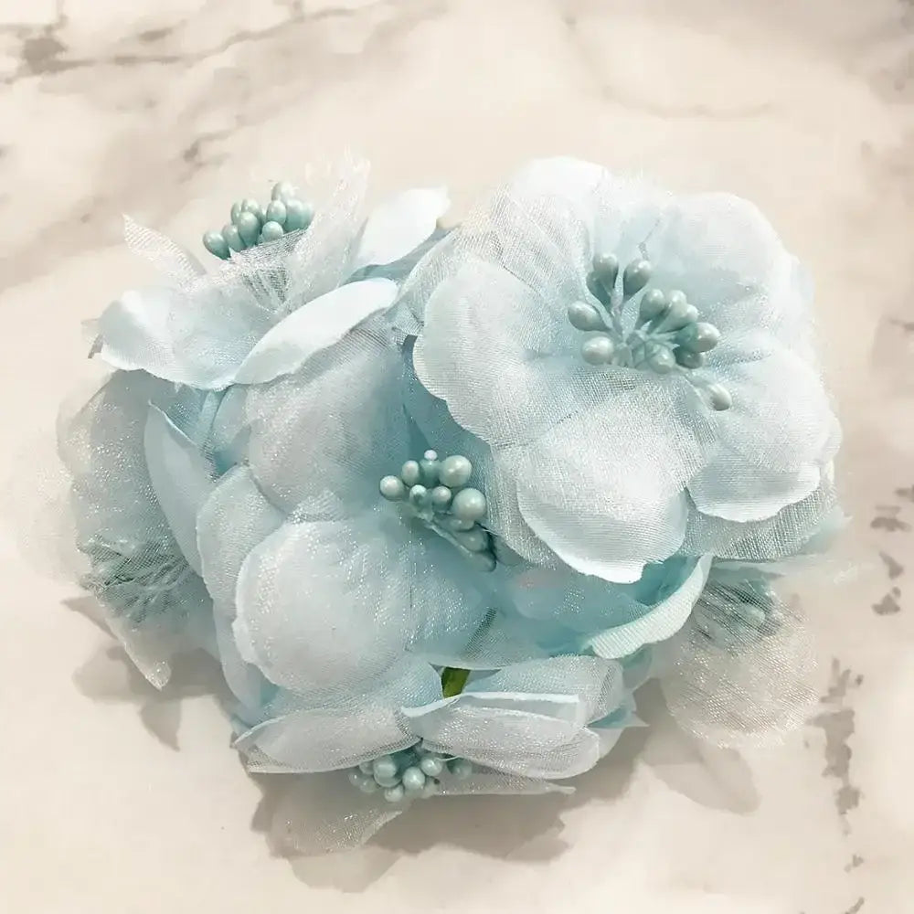 A delicate light blue flower stamen berries bundle made of sheer fabric with tiny pearl beads for kitchen cake decor