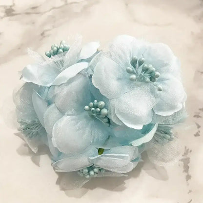 A delicate light blue flower stamen berries bundle made of sheer fabric with tiny pearl beads for kitchen cake decor