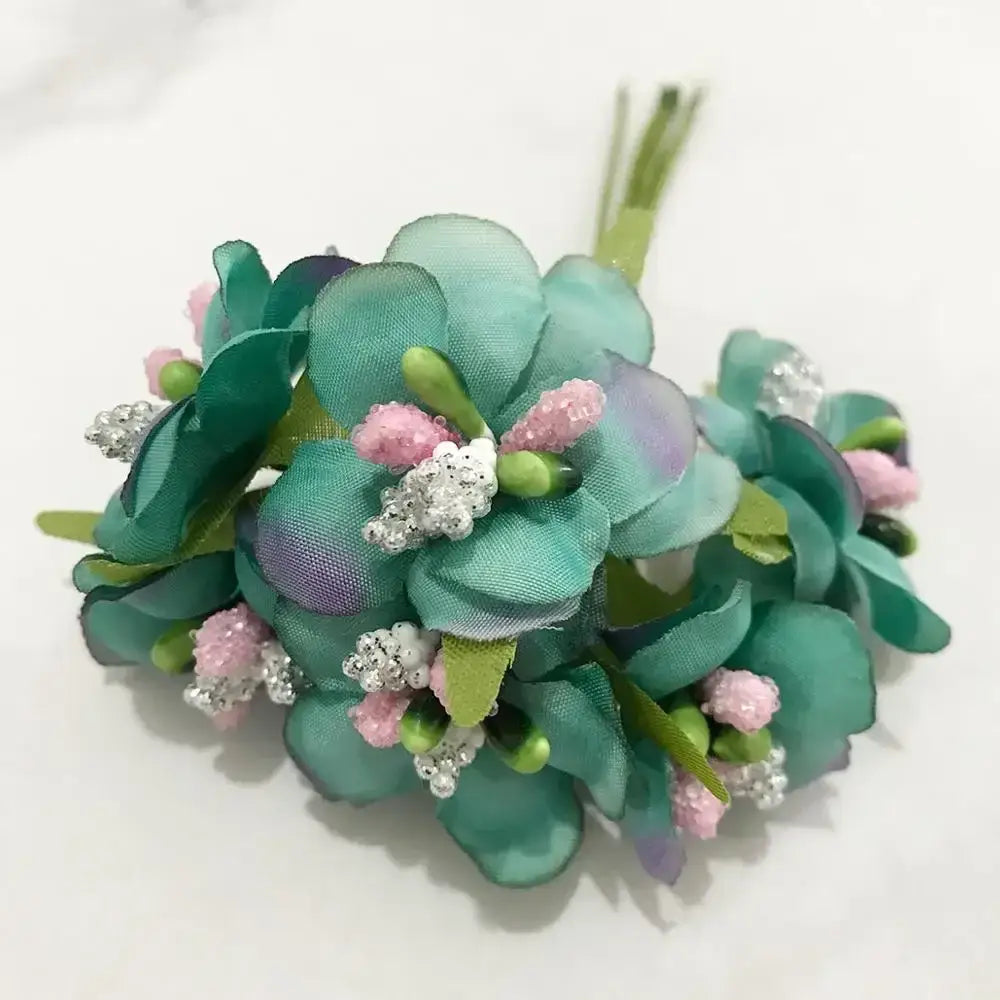 A delicate stamen berries bundle with teal and purple satin blue flower stamen and pink beaded accents for decor