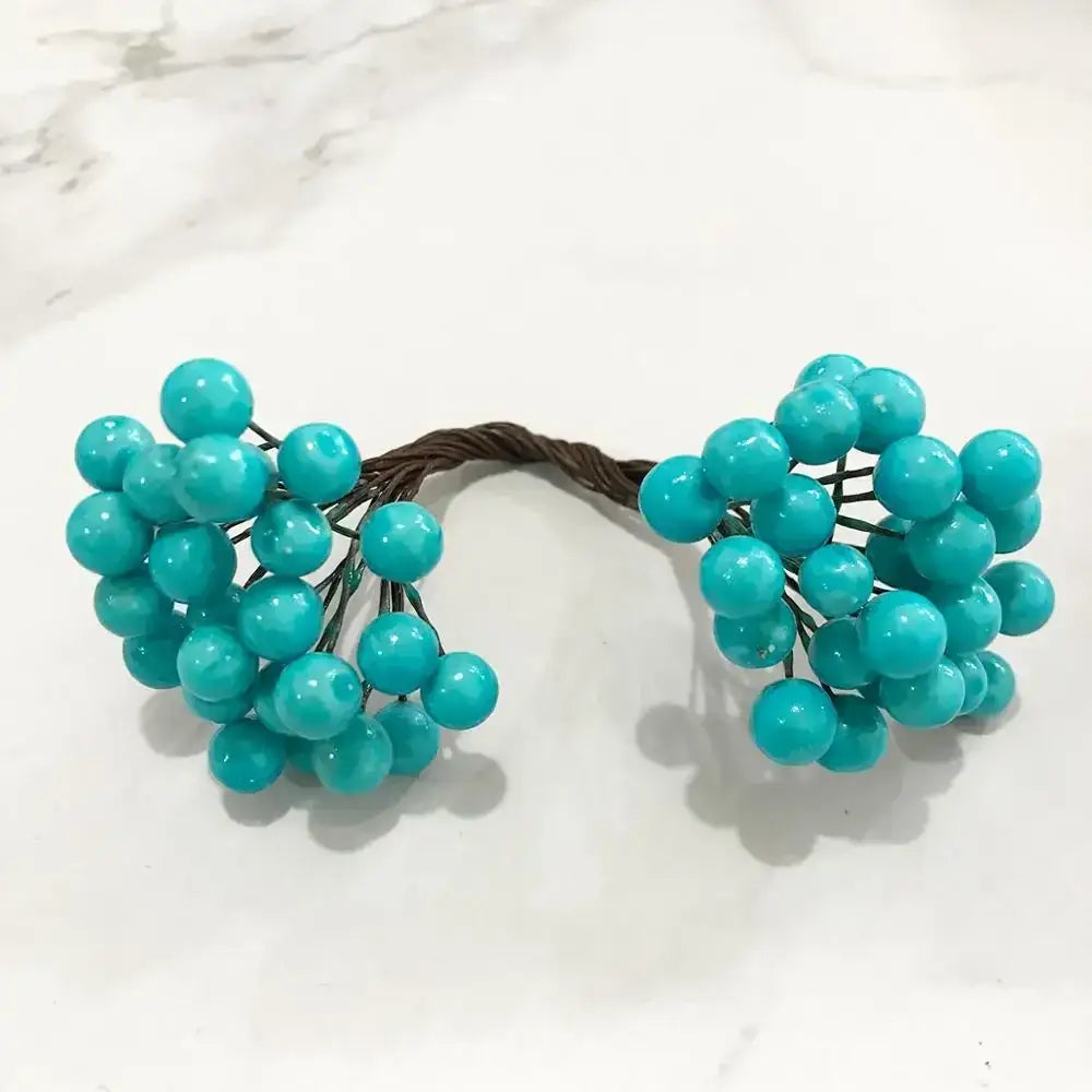 Turquoise faux berry cluster with wire stems in a blue flower stamen berries bundle for kitchen cake decor