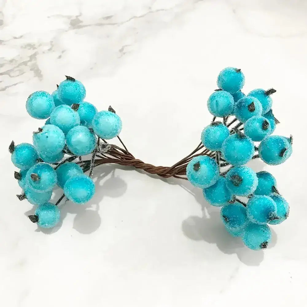 Vibrant turquoise flower stamen berries bundle with frosted texture and dark green stems for kitchen cake decor