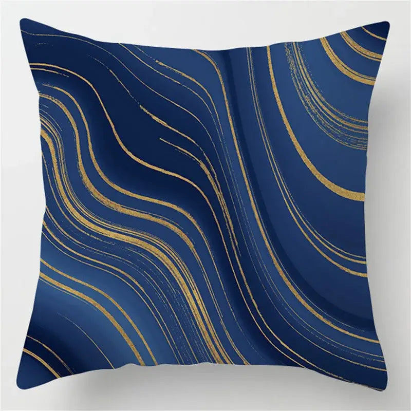 Square throw pillow with a deep navy blue background and flowing gold brushstroke decorbites blue geometric design