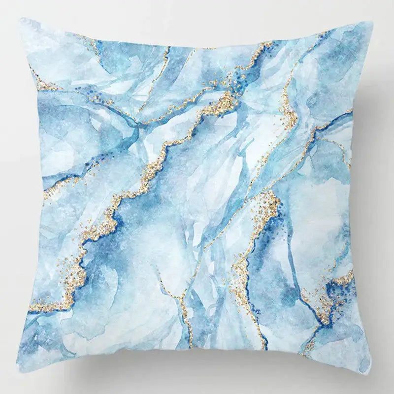 A square throw pillow with a blue geometric marble watercolor pattern and gold veining for living room decorbites decor