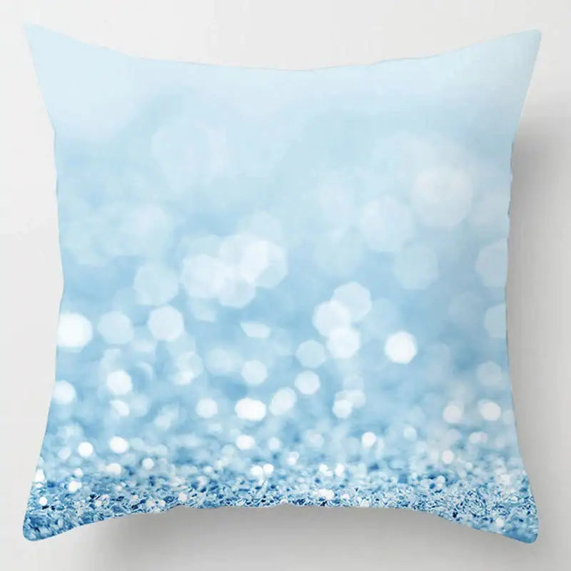 A blue geometric marble throw pillow with a soft light blue gradient and sparkling texture for living room decor