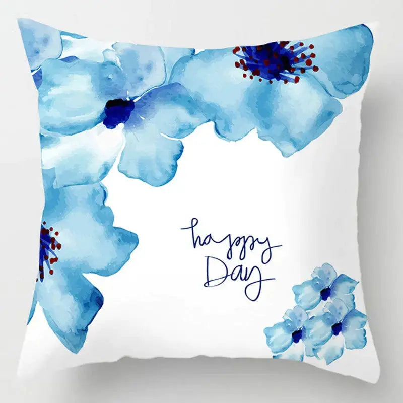 A white throw pillow with blue floral watercolor and happy day text for decorbites blue geometric marble decor