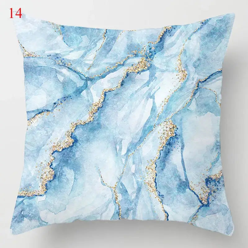 Blue geometric marble throw pillow with white and blue marble pattern and gold glitter accents for living room decor