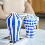 Two ceramic vases in blue geometric quilted and bold stripe patterns for decorbites blue geometric living room decor