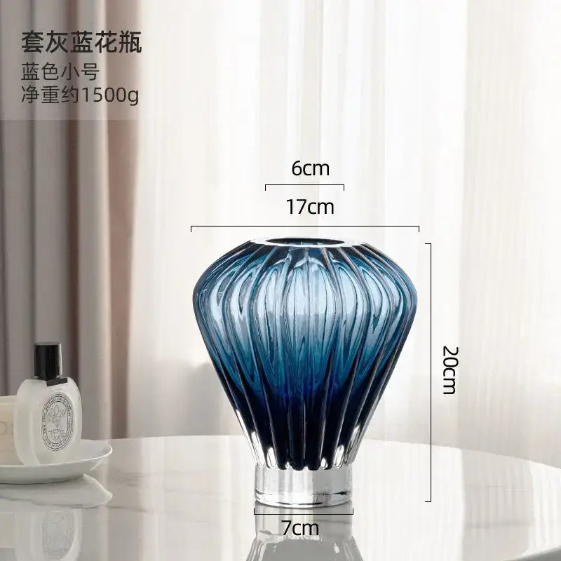 A sleek blue glass hot air balloon vase with a fluted design and clear base for living room ribbed decor