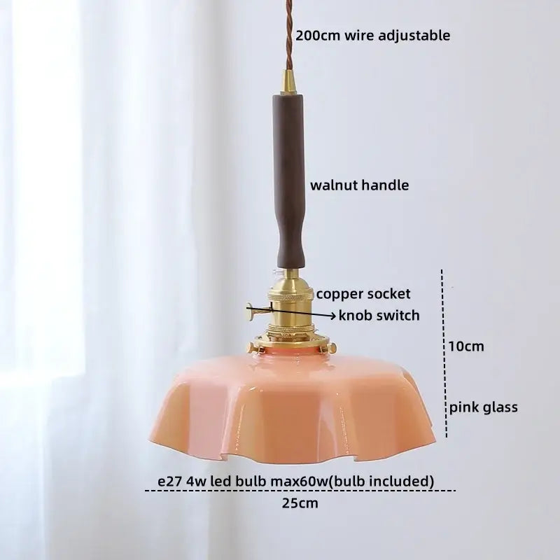A delicate pink glass pendant lamp with walnut handle and brass accents for decorbites blue glass led lighting