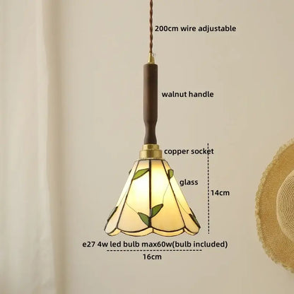 A warm-toned pendant lamp with green leaf motifs amber glass walnut handle and copper socket by decorbites blue glass led