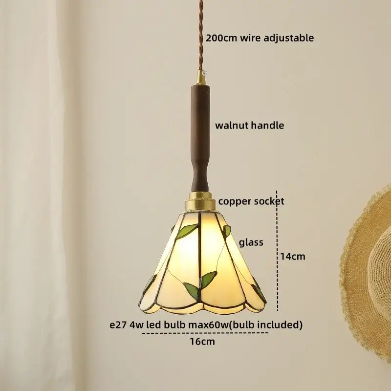 A warm-toned pendant lamp with green leaf motifs amber glass walnut handle and copper socket by decorbites blue glass led