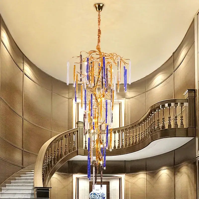 Blue and gold crystal pendant chandelier with a golden branch frame and hanging blue and clear glass rods by decorbites crystal pendant