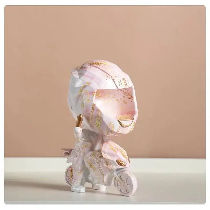 A pink and white geometric motorcycle figurine with gold accents featured in blue and gold marble helmet decorbites decorative key storage