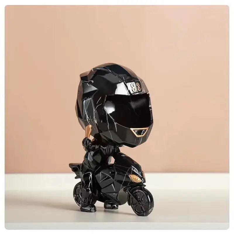 Black glossy motorcycle rider figurine with gold geometric accents on blue and gold marble helmet watch display decorbites decorative key storage
