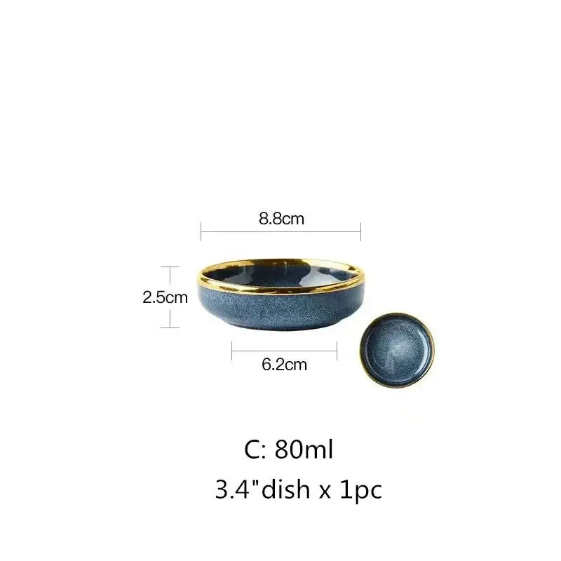 A sleek dark blue ceramic plate set bowl with glossy gold rim and matching lid in blue gradient ceramic plate design