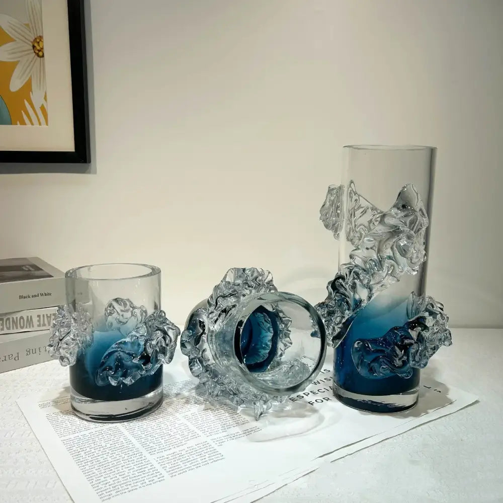 Clear glass vase with intricate sculpted wave-like embellishments and a blue gradient wavy interior for living room decor