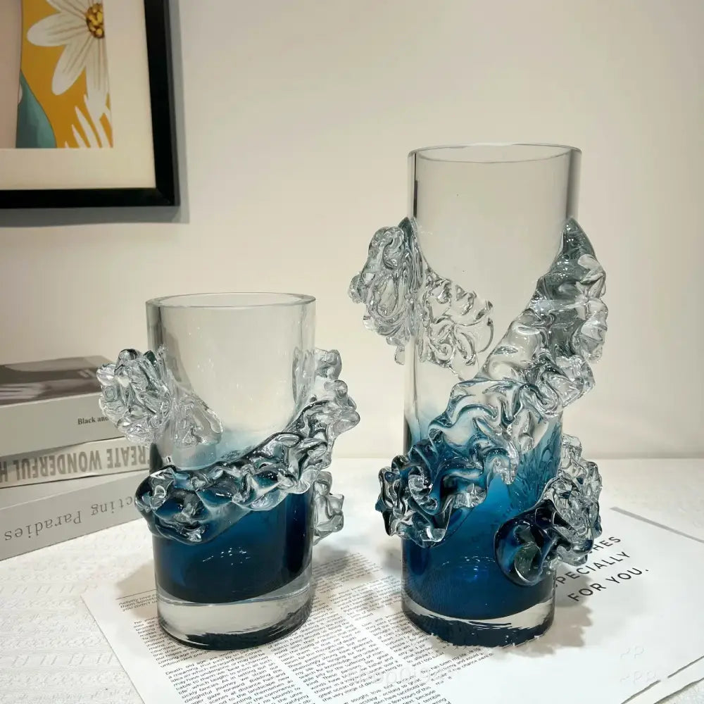Clear glass vases with intricate wave-like sculptural details and a blue gradient wavy tint at the base for floral decor