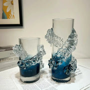 Clear glass vases with intricate wave-like sculptural details and a blue gradient wavy tint at the base for floral decor