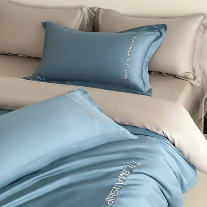 Light blue satin pillowcases with white embroidered text from decorbites cotton solid color bedding set