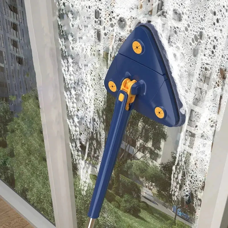 Blue and yellow rotating telescopic triangle mop with sponge head covered in soapy foam for window cleaning