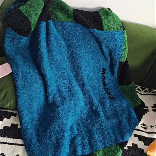 Blue green and black flannel sofa blanket with momochi embroidery made of cozy terry cloth for decorbites cozy use