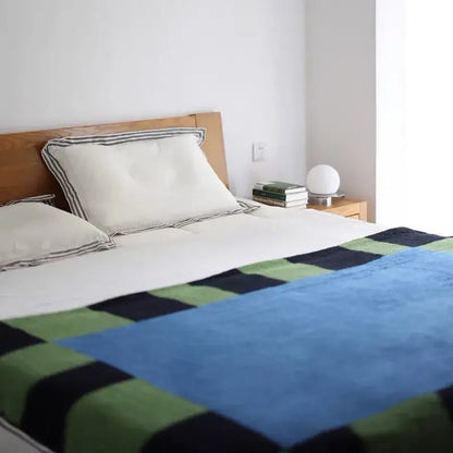Cozy flannel sofa blanket in blue green and black geometric blocks ideal for decorbites cozy bedroom decor
