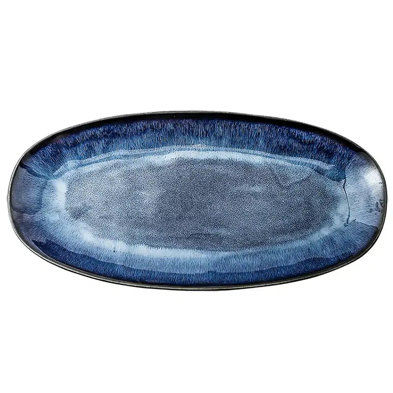 Blue kiln glazed oval ceramic sushi plate with gradient navy to light blue glaze and textured ridges by decorbites