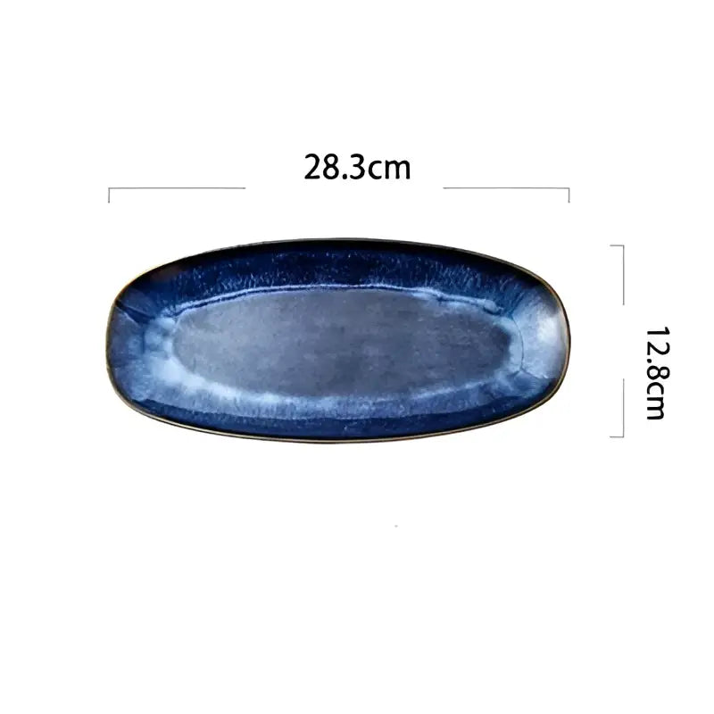 A sleek oval ceramic sushi plate with blue kiln glazed gradient from navy to lighter shades by decorbites blue kiln
