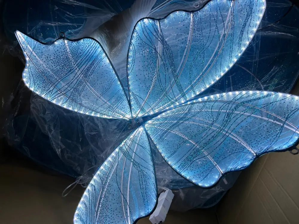 Blue lace led butterfly light fixture with translucent wings and glowing internal lights for wedding decor