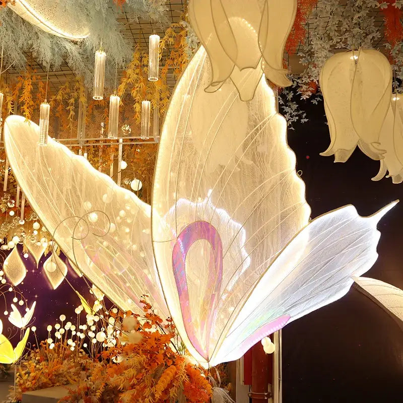 Glowing white butterfly wings with iridescent pink and purple accents made of translucent material blue lace led decorbites