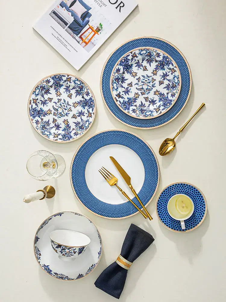 Blue lotus dinnerware set with intricate blue and white floral porcelain design and gold-trimmed edges by decorbites blue lotus