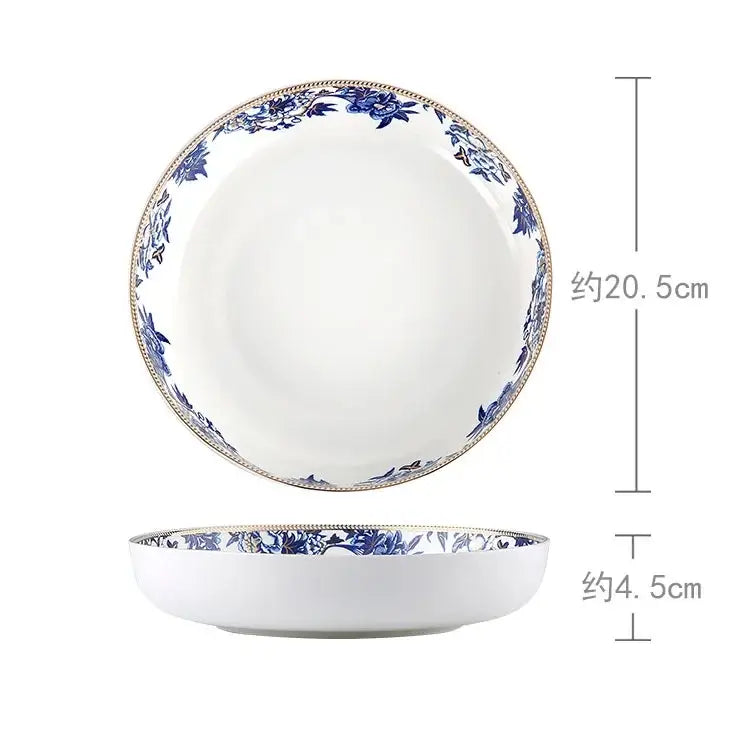 A white ceramic bowl with blue floral pattern and gold trim from decorbites blue lotus dinnerware set