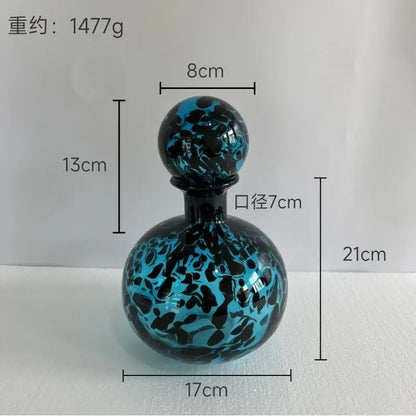 Glossy blue and black marbled glass decanter with spherical stopper for decorbites leopard print glass vase decor