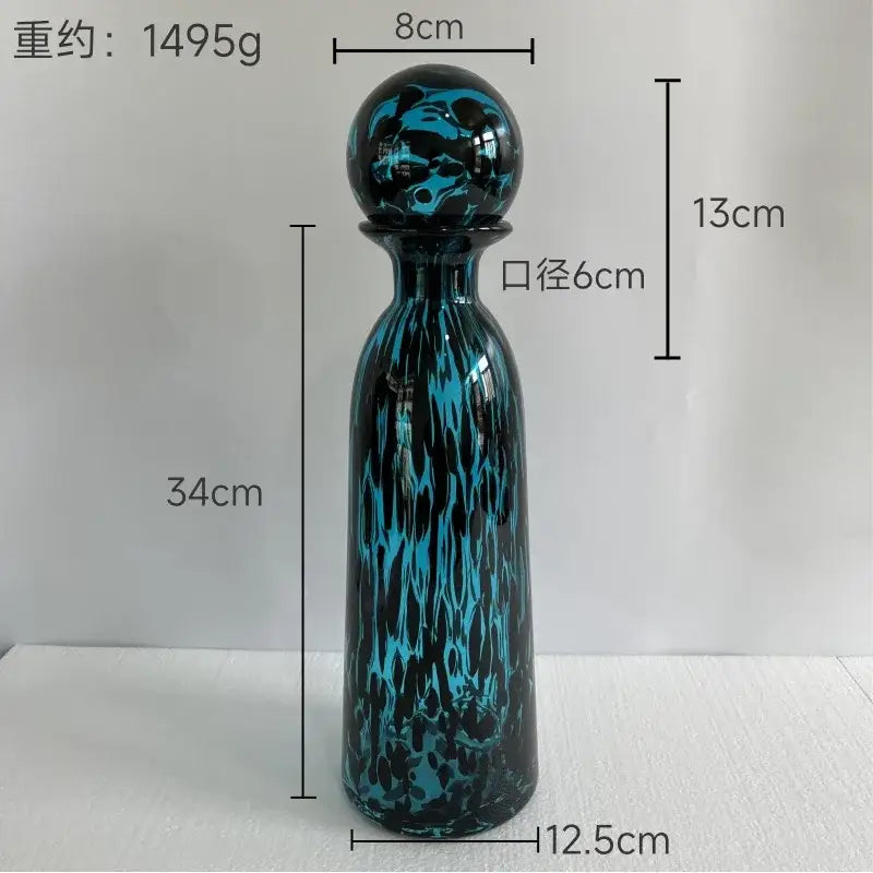A tall slender leopard print glass vase with lid in glossy black and turquoise decorbites leopard print design for living room decor