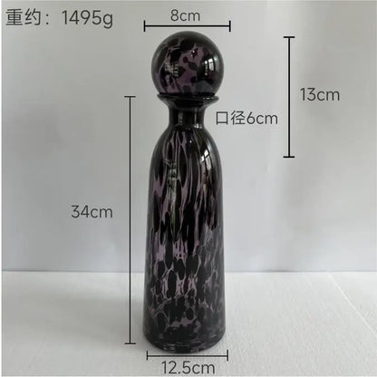 A tall slender blue marbled leopard print glass vase with lid and spherical stopper for decorbites leopard print decor