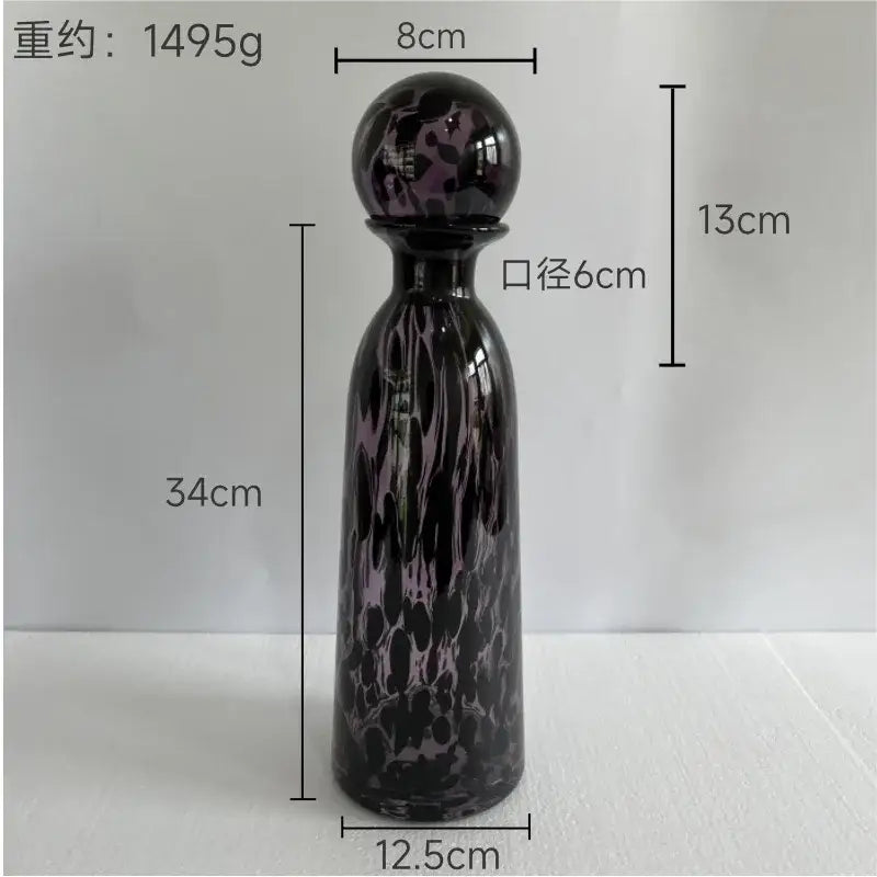A tall slender blue marbled leopard print glass vase with lid and spherical stopper for decorbites leopard print decor