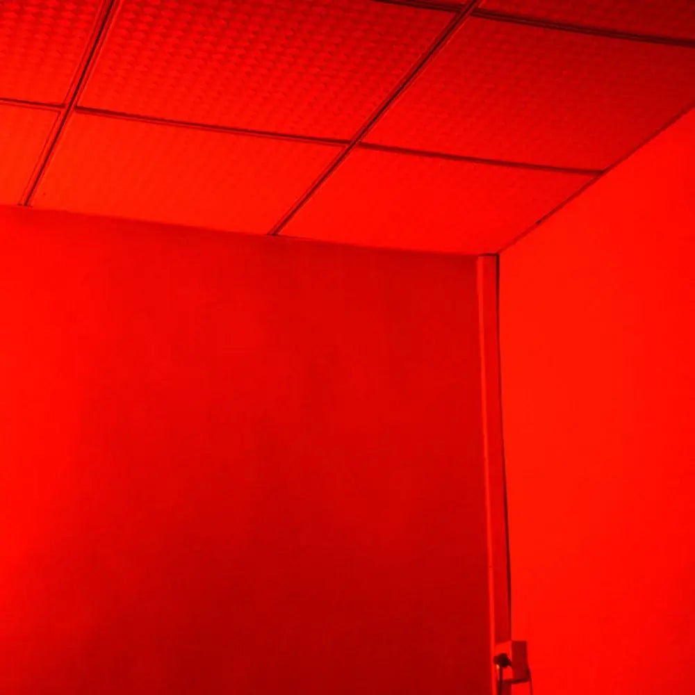 Blue metallic 20w rgb strobe lights illuminating a red-tinted ceiling with square panels and grid lines in a party room