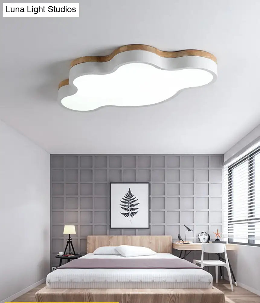Blue and natural wood cloud flush mount ceiling lamp with white illuminated body and wooden trim for kids bedroom