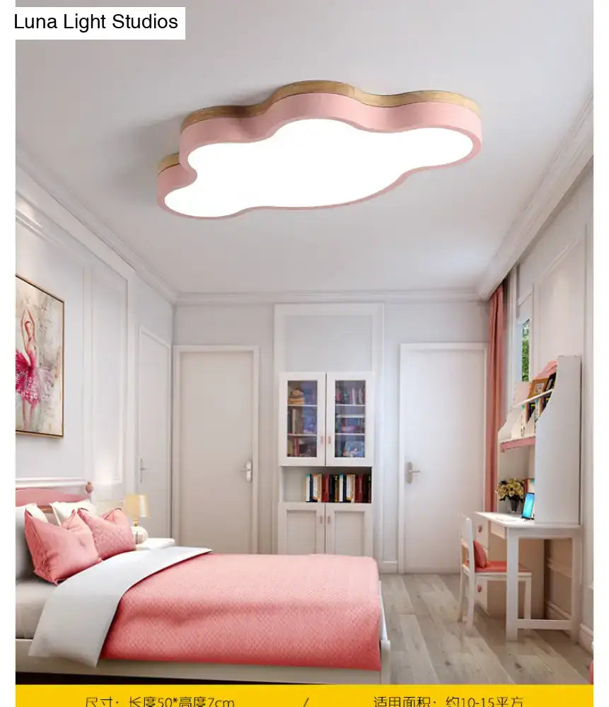 Pink flush mount ceiling lamp shaped like a cloud with wooden trim designed for kids bedroom lighting