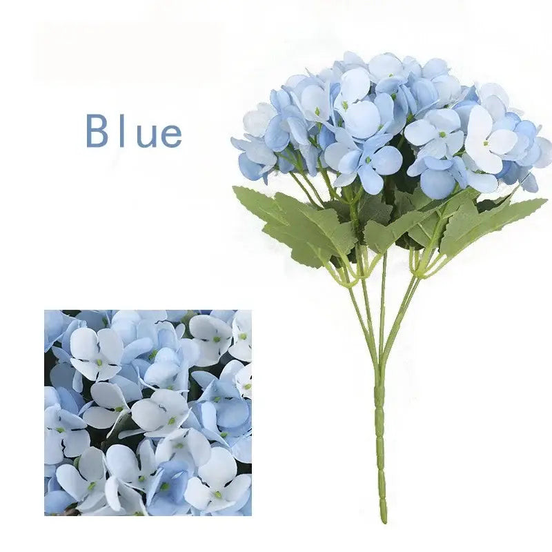 A delicate bouquet of silk fake flowers featuring blue peony and tea rose in soft blue and white hues for home decor