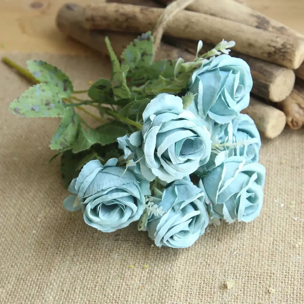A delicate bouquet of light blue silk fake flowers featuring blue peony and tea rose for home garden decor