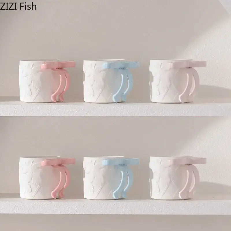 White ceramic baby bottle holders with pastel pink and blue silicone handles from decorbites bowknot ceramic saucer set