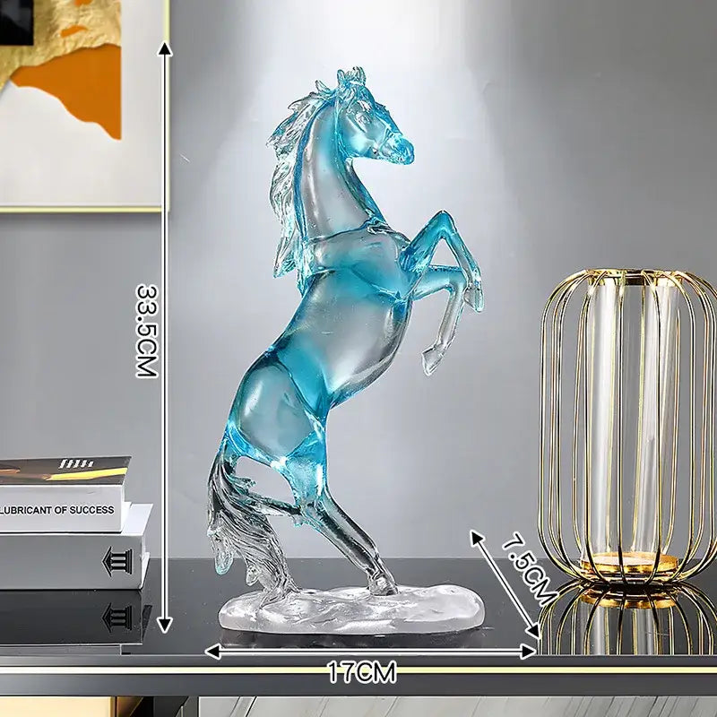A translucent blue glass horse resin ornament with a rearing stance and detailed mane on a clear base by decorbites