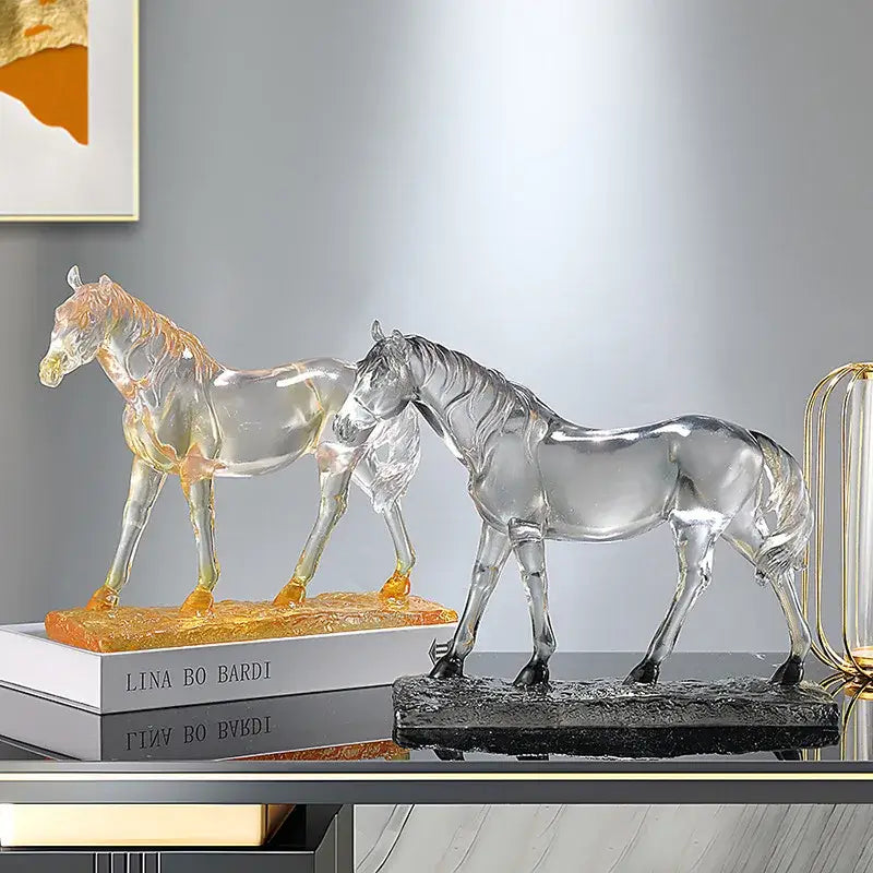 Two translucent glass horse resin ornaments with amber and clear highlights on textured bases for decorbites horse decor